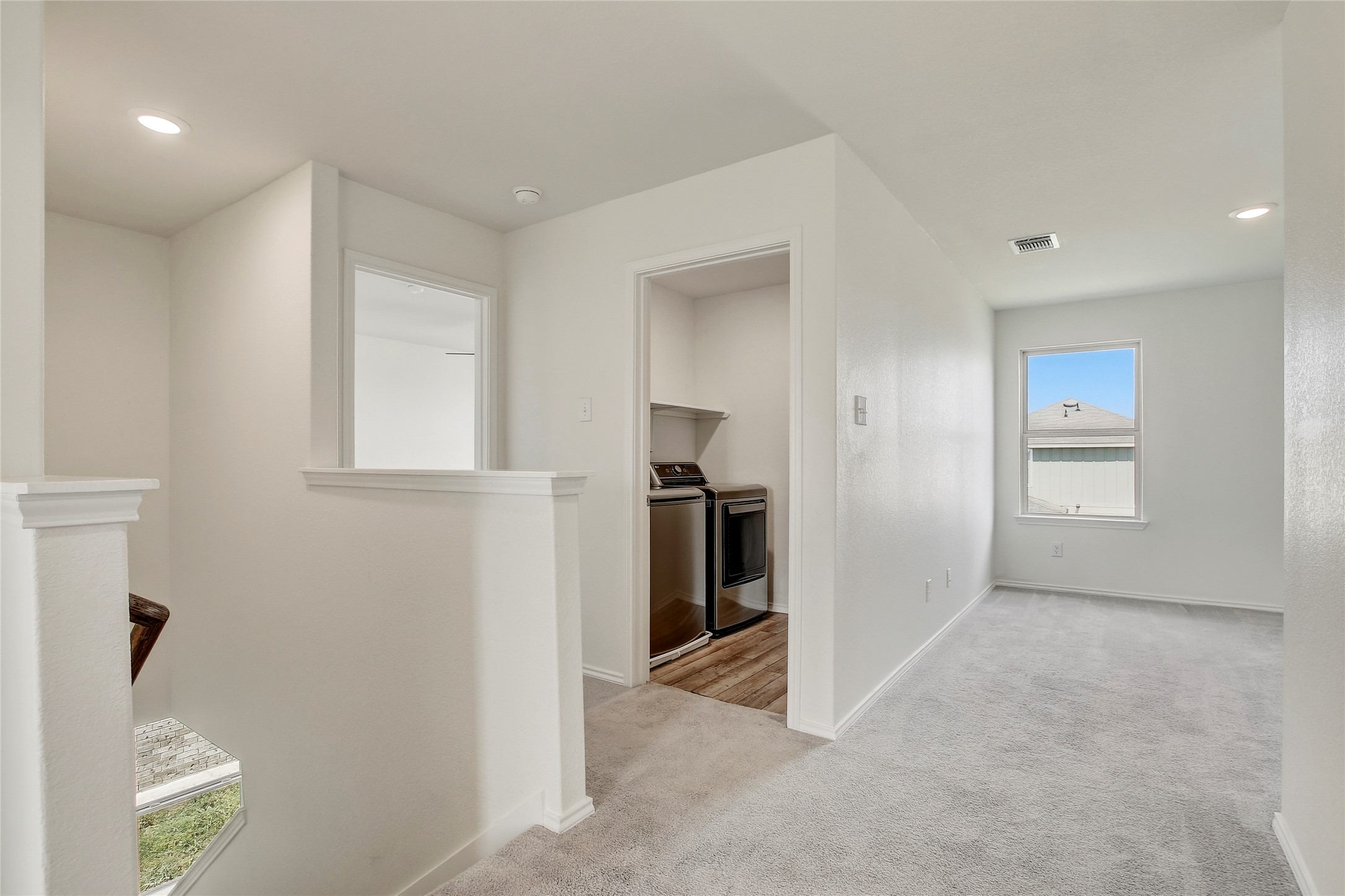449 Stone Water Lane Jarrell, TX 76537 - Photo 18 of 18 Upper-level landing featuring light gray carpeting, recessed lighting, and white walls