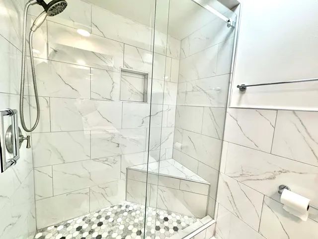 a bathroom with a glass door shower