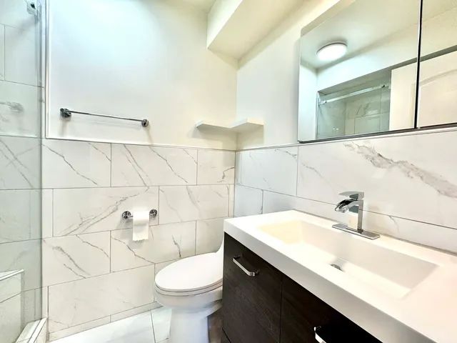 a bathroom with a sink toilet and shower