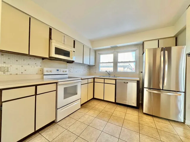 a kitchen with a stove top oven sink and cabinets