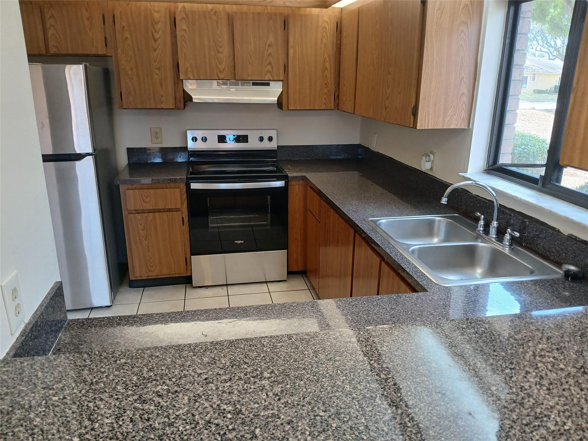 4703 Cherry Road West Palm Beach, FL 33417 - Photo 3 of 3 a kitchen with a sink stove and refrigerator