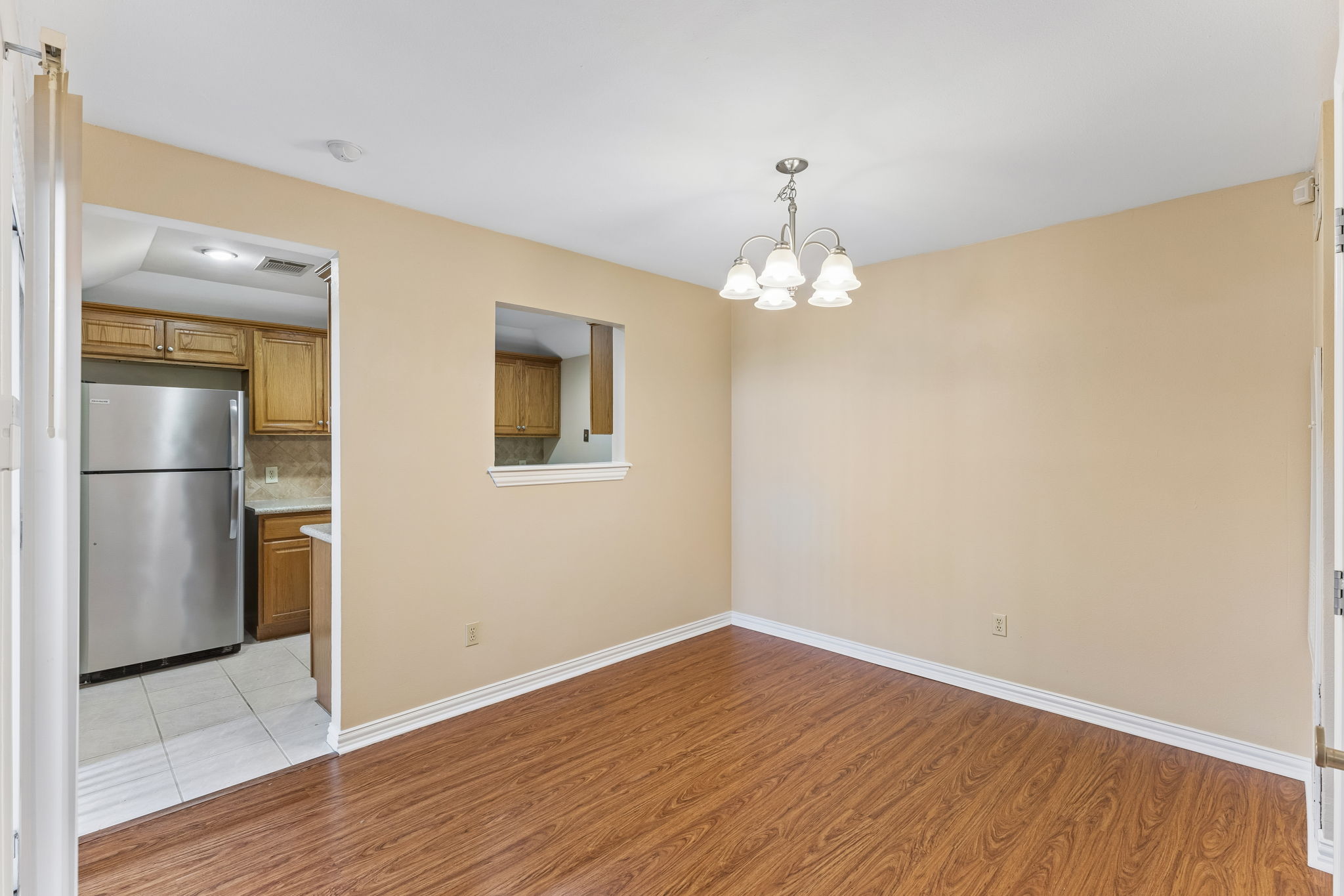 8340 Fathom Circle, Unit 103 Austin, TX 78750 - Photo 11 of 30 a view of wooden floor and chandelier in a room