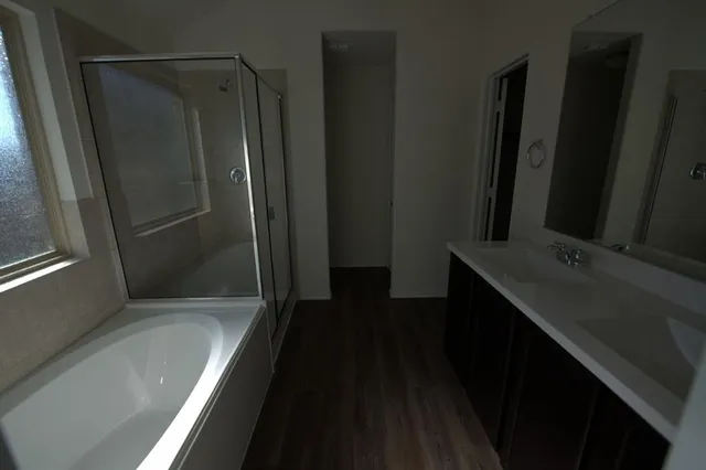 a bathroom with a double vanity sink and mirror