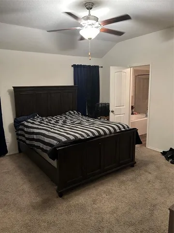 a bedroom with a bed and a ceiling fan
