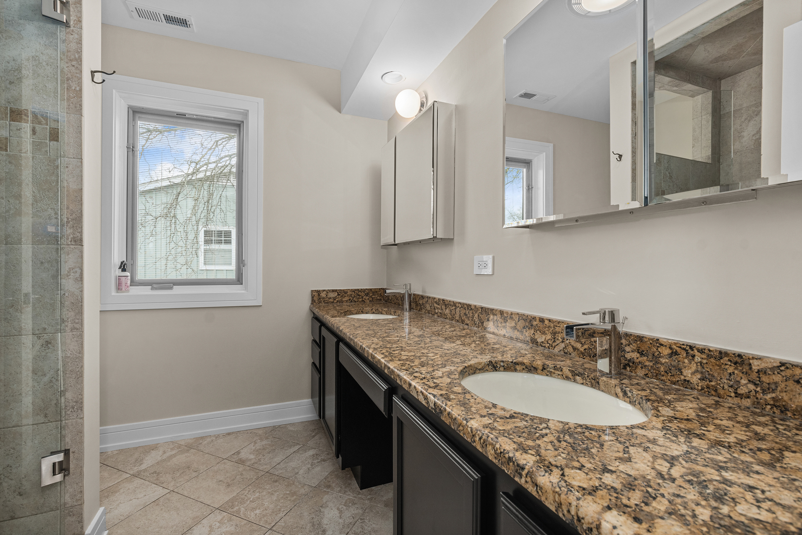20 Colony Lane Deerfield, IL 60015 - Photo 26 of 33 a bathroom with a granite countertop sink and a mirror