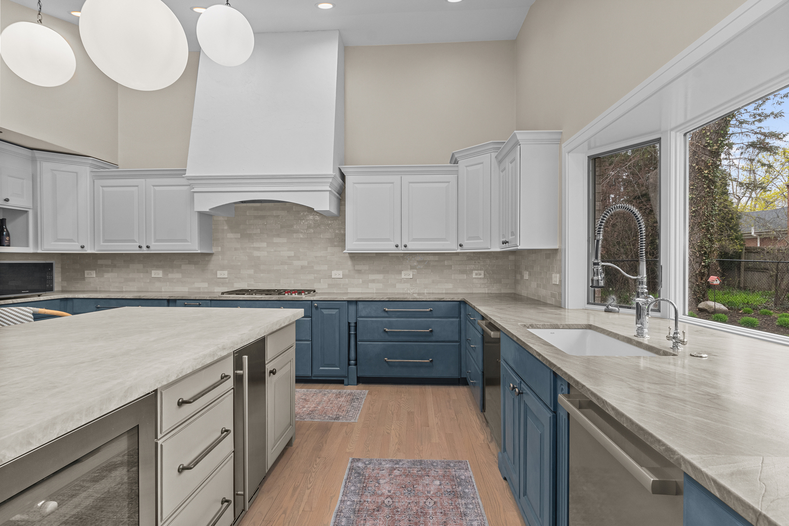 20 Colony Lane Deerfield, IL 60015 - Photo 6 of 33 a kitchen with kitchen island granite countertop a sink a stove cabinets and wooden floor