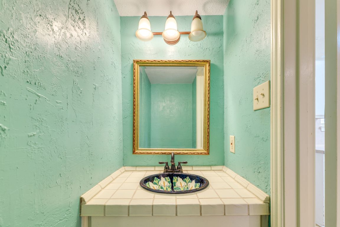 9226 Jollyville Road, Unit 132 Austin, TX 78759 - Photo 18 of 25 Bathroom featuring a textured wall and vanity