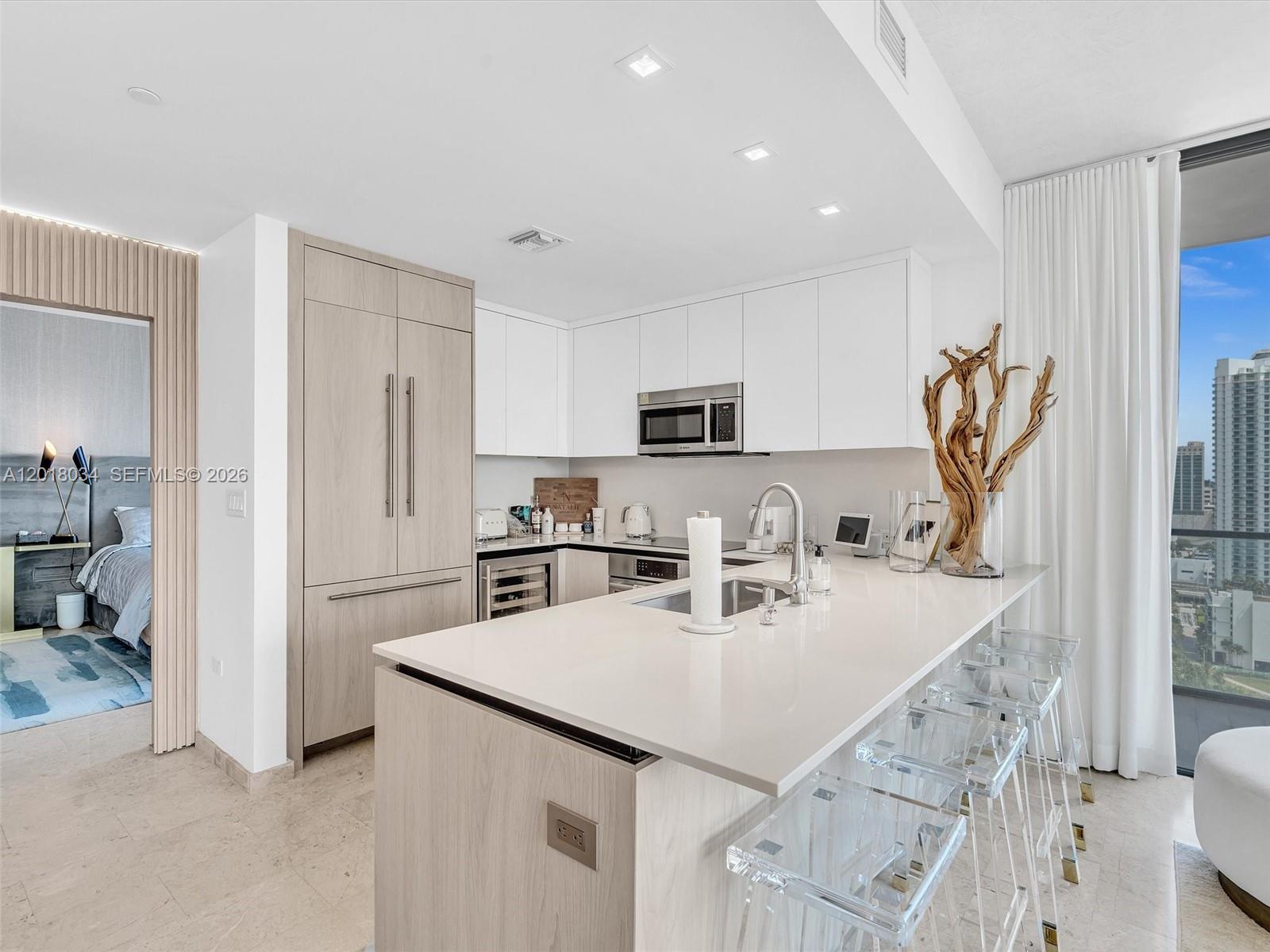 88 Southwest 7th Street, Unit 2011 Miami, FL 33130 - Photo 15 of 55 a kitchen with granite countertop a sink appliances and cabinets