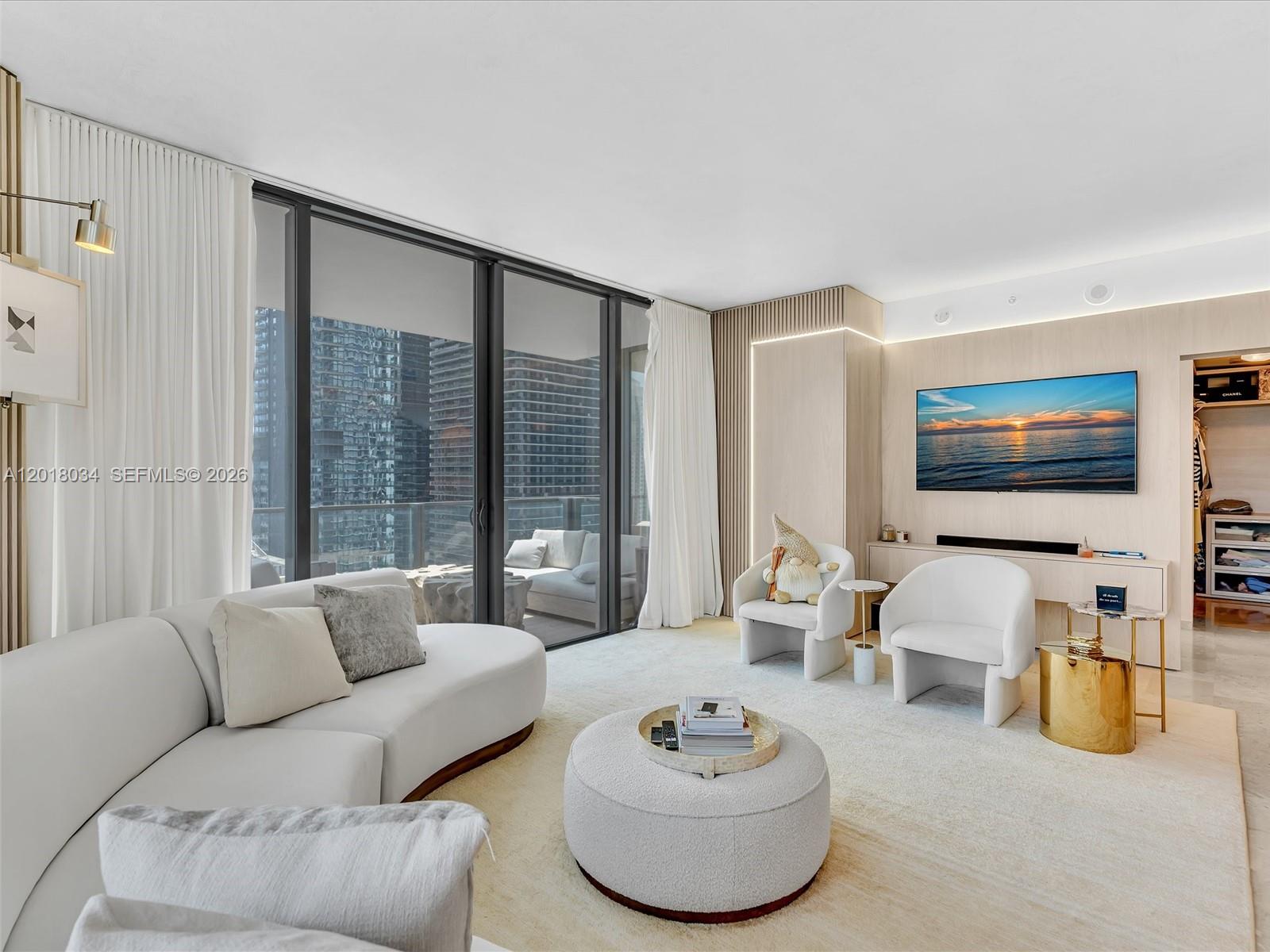 88 Southwest 7th Street, Unit 2011 Miami, FL 33130 - Photo 18 of 55 a living room with furniture and a flat screen tv