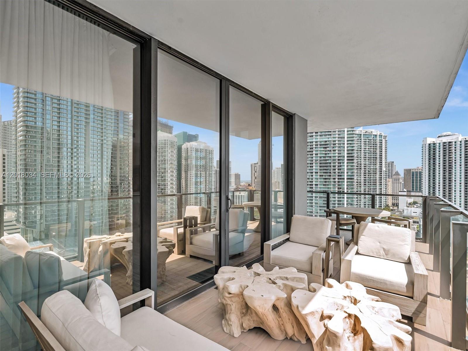 88 Southwest 7th Street, Unit 2011 Miami, FL 33130 - Photo 24 of 55 a living room with furniture and a floor to ceiling window