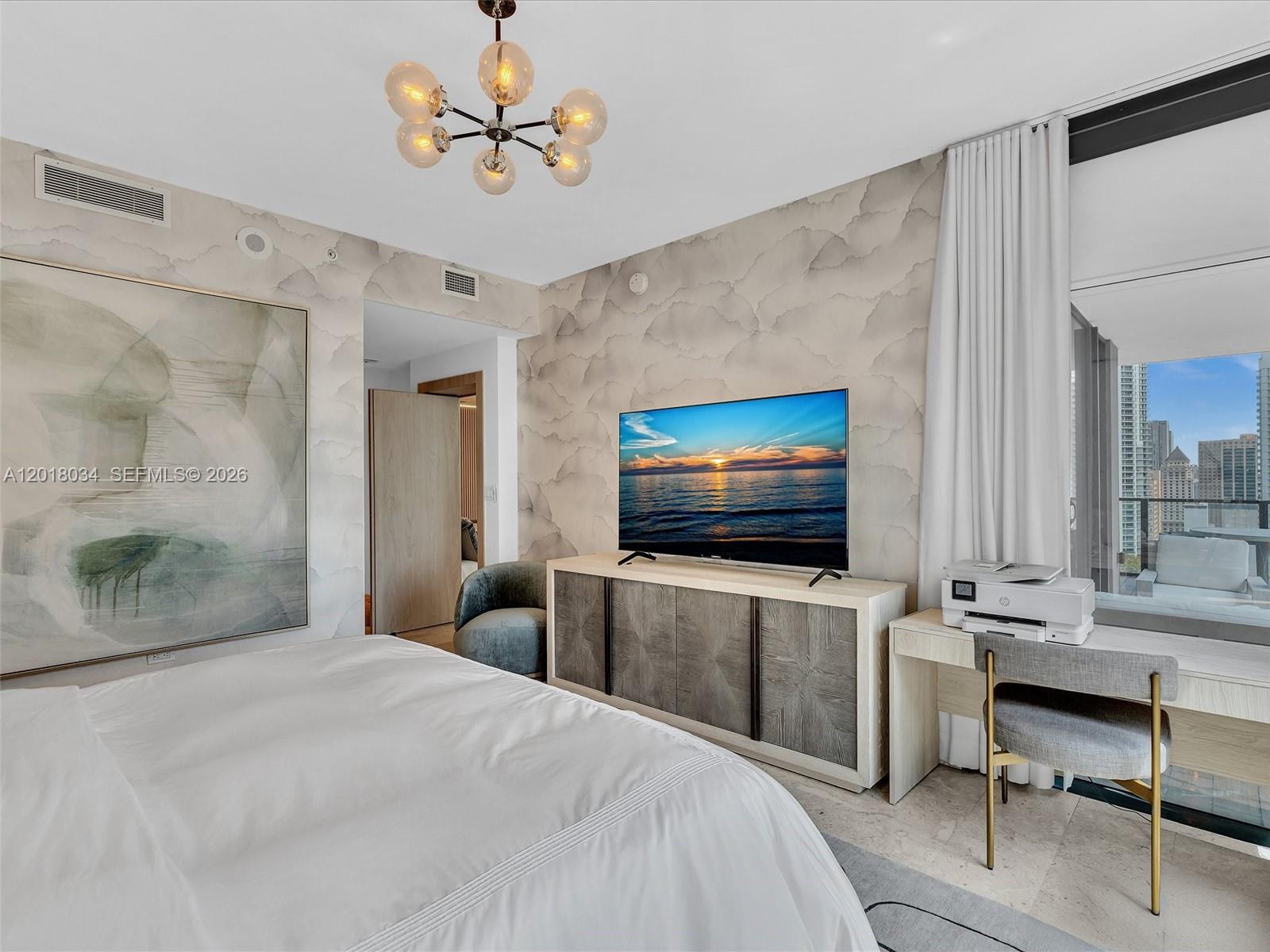 88 Southwest 7th Street, Unit 2011 Miami, FL 33130 - Photo 34 of 55 a bedroom with a bed and a flat screen tv