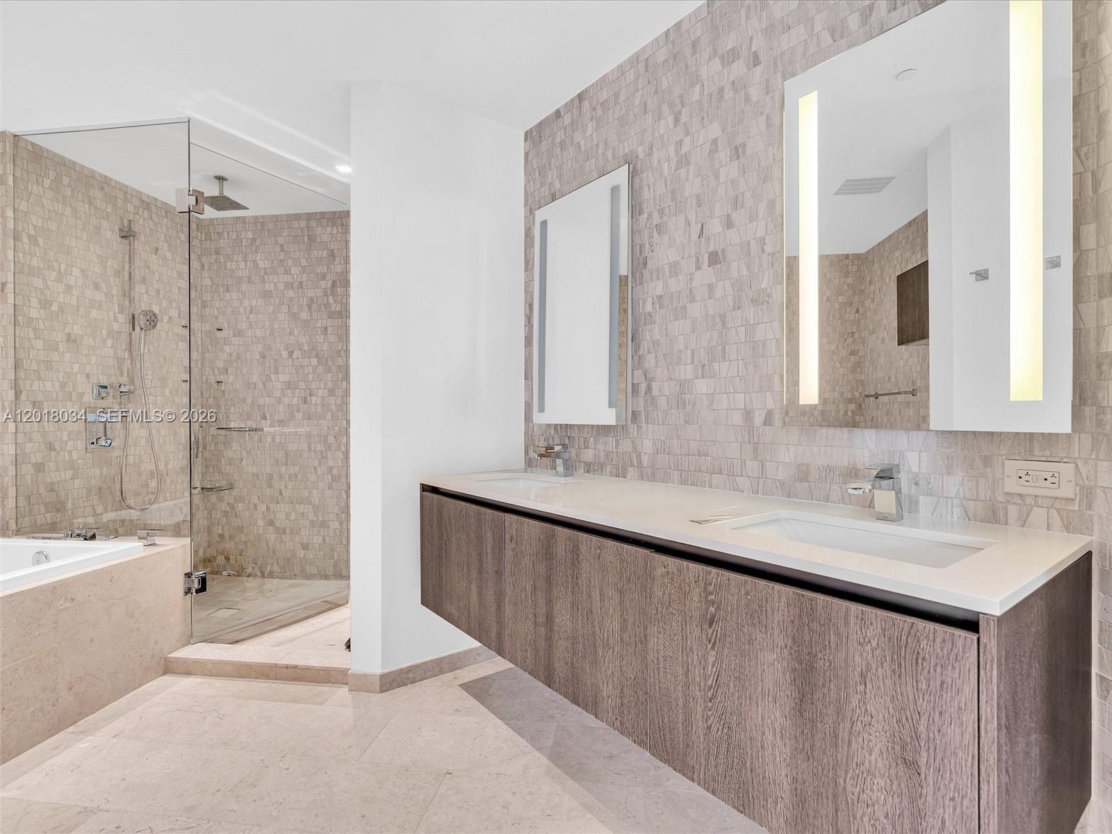 88 Southwest 7th Street, Unit 2011 Miami, FL 33130 - Photo 36 of 55 a bathroom with a double vanity sink mirror double and bathtub