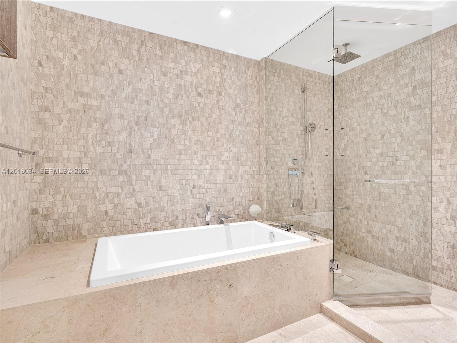 88 Southwest 7th Street, Unit 2011 Miami, FL 33130 - Photo 37 of 55 a bathroom with a bathtub and shower