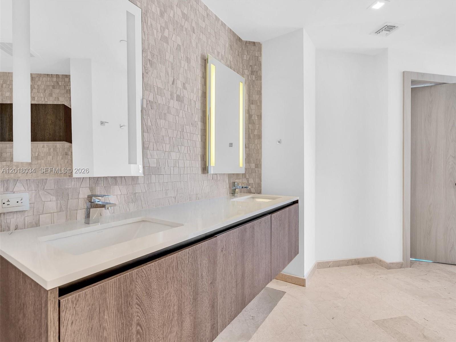 88 Southwest 7th Street, Unit 2011 Miami, FL 33130 - Photo 38 of 55 a bathroom with a sink and a mirror