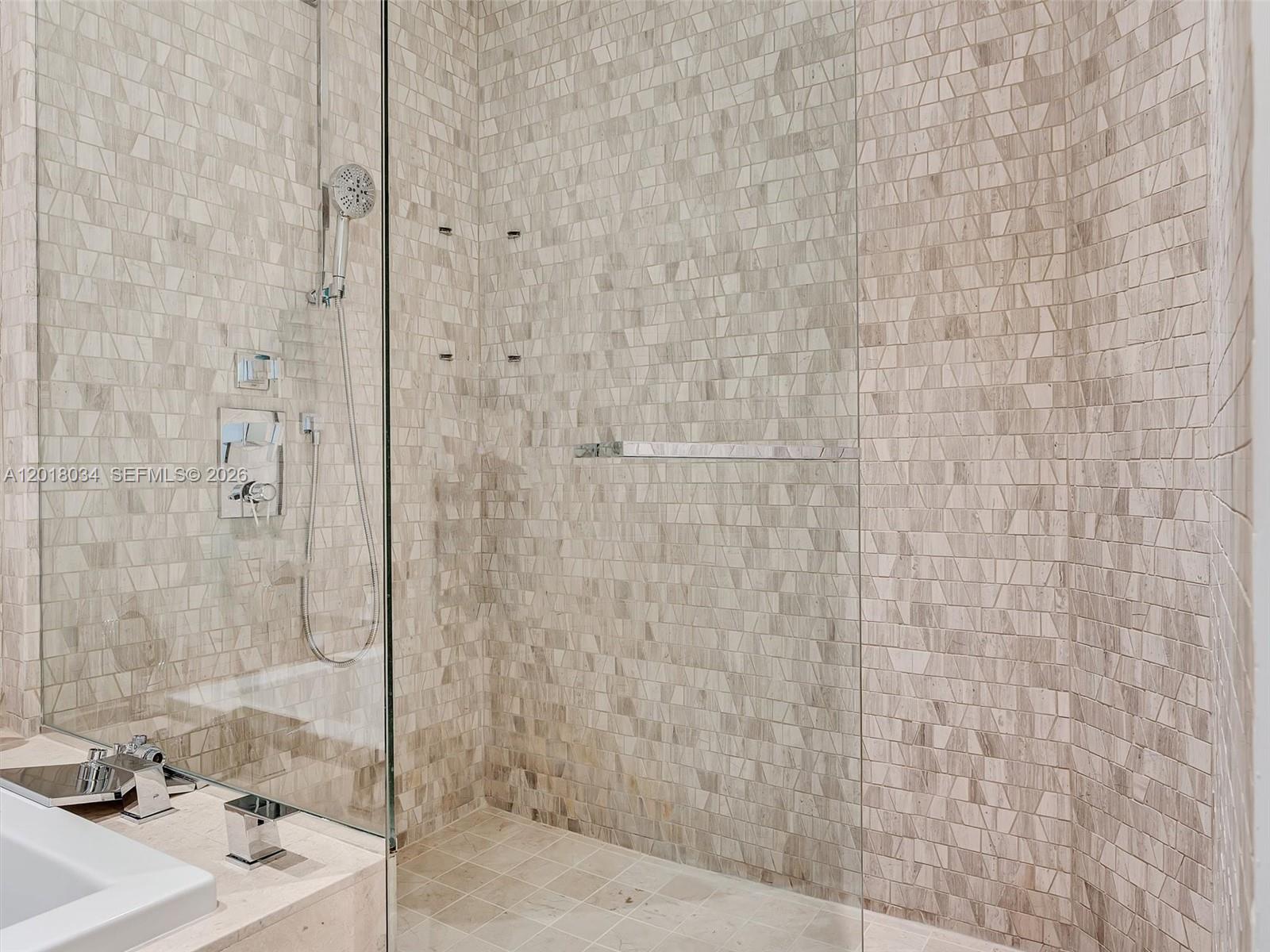 88 Southwest 7th Street, Unit 2011 Miami, FL 33130 - Photo 40 of 55 a bathroom with a shower and a sink