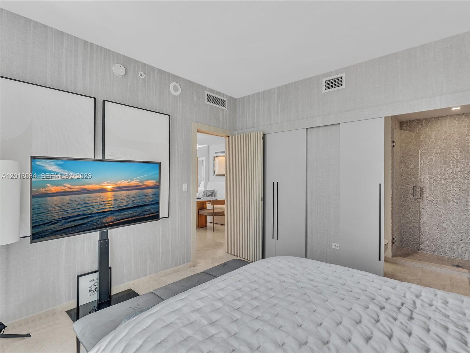 88 Southwest 7th Street, Unit 2011 Miami, FL 33130 - Photo 42 of 55 a bedroom with a bed and a flat screen tv