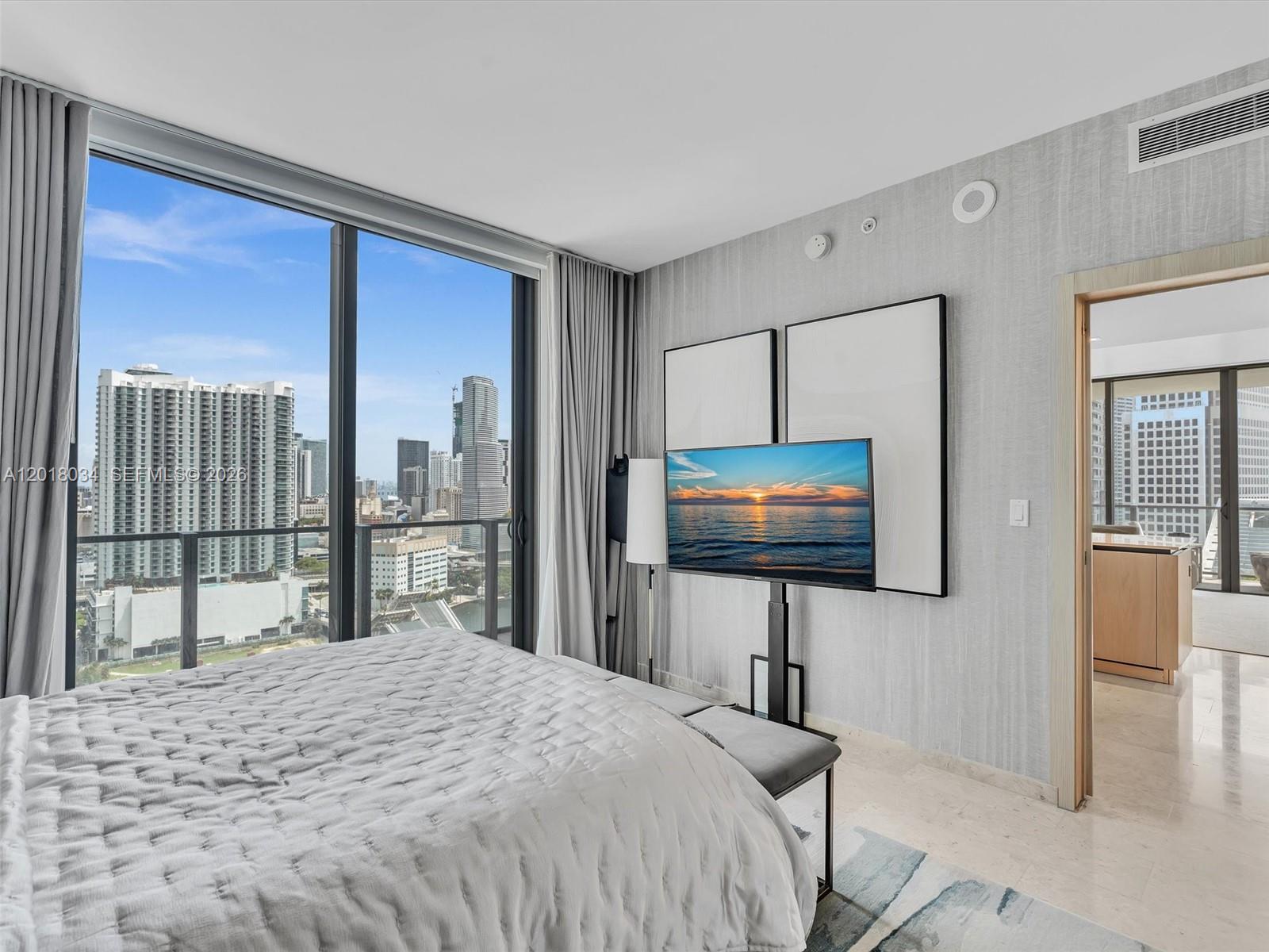 88 Southwest 7th Street, Unit 2011 Miami, FL 33130 - Photo 43 of 55 a bedroom with a bed and a flat screen tv