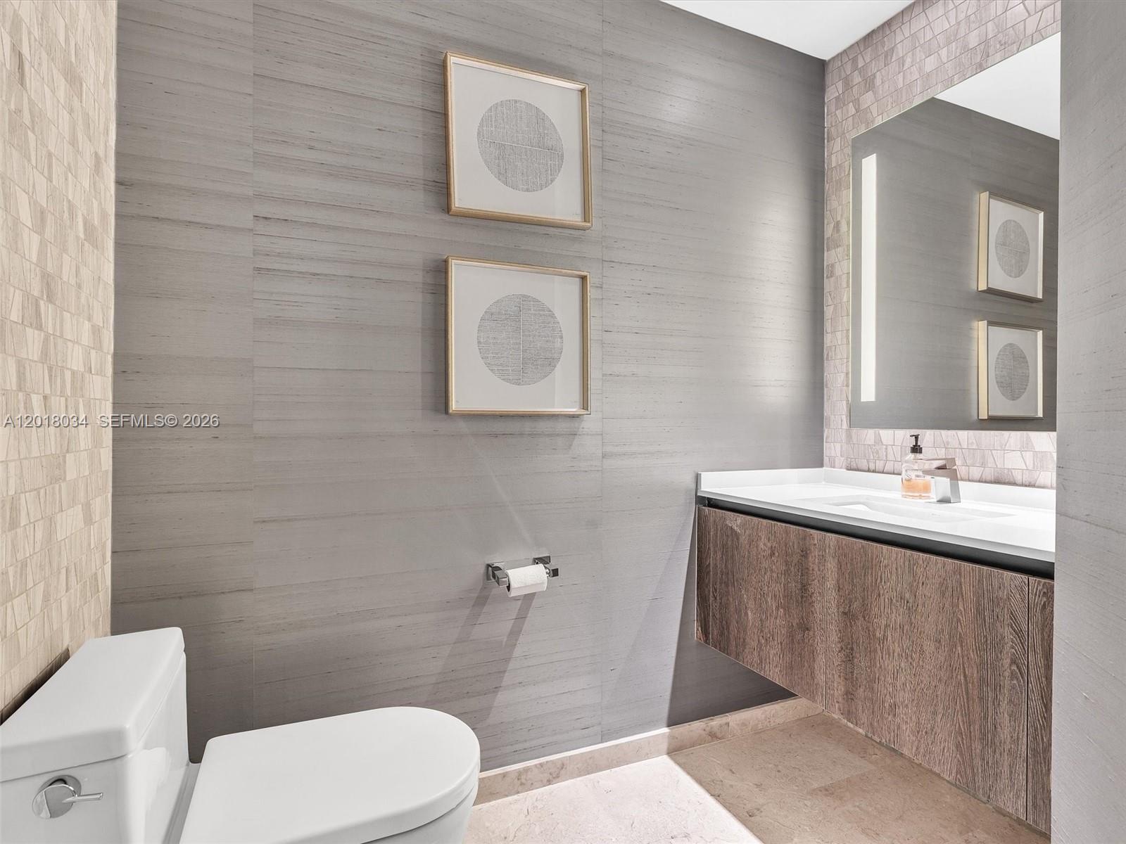 88 Southwest 7th Street, Unit 2011 Miami, FL 33130 - Photo 6 of 55 a bathroom with a toilet sink and mirror