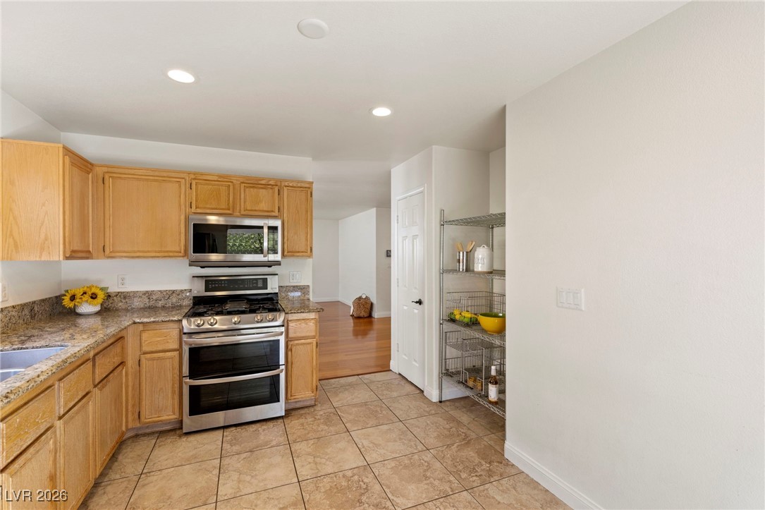 1131 Cathedral Ridge Street Henderson, NV 89052 - Photo 11 of 32 Plenty of counters and cabinets, with an oven that’s barely used and looks brand new inside