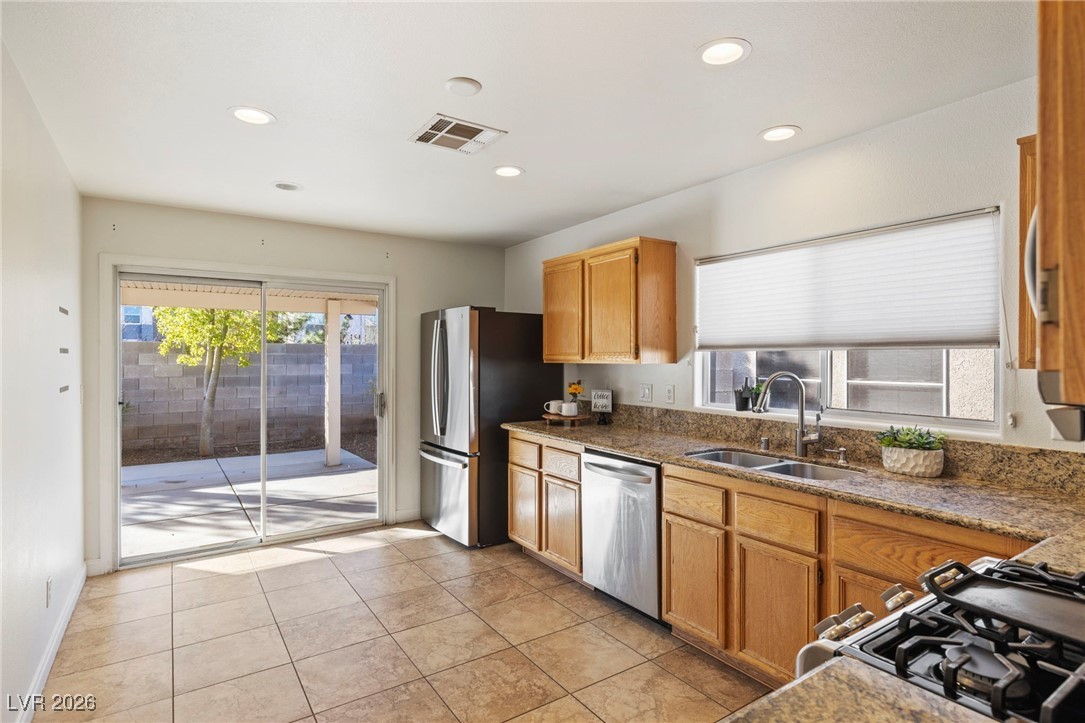 1131 Cathedral Ridge Street Henderson, NV 89052 - Photo 9 of 32 Sliding doors create an indoor-outdoor feel, bringing in plenty of natural light, with a large over-the-sink window