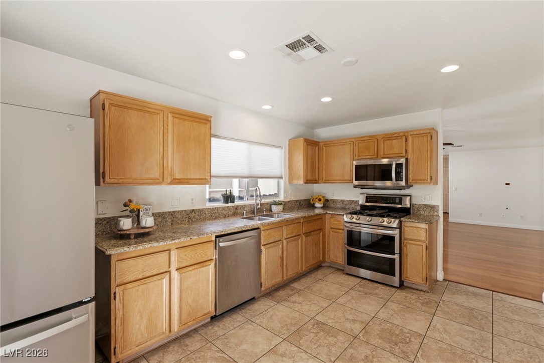 1131 Cathedral Ridge Street Henderson, NV 89052 - Photo 10 of 32 Wide doorway connects the kitchen and living room providing easy flow