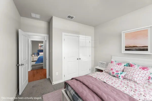 a bedroom with a bed and a painting on the wall