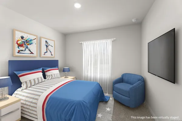 a bedroom with bed couch and window