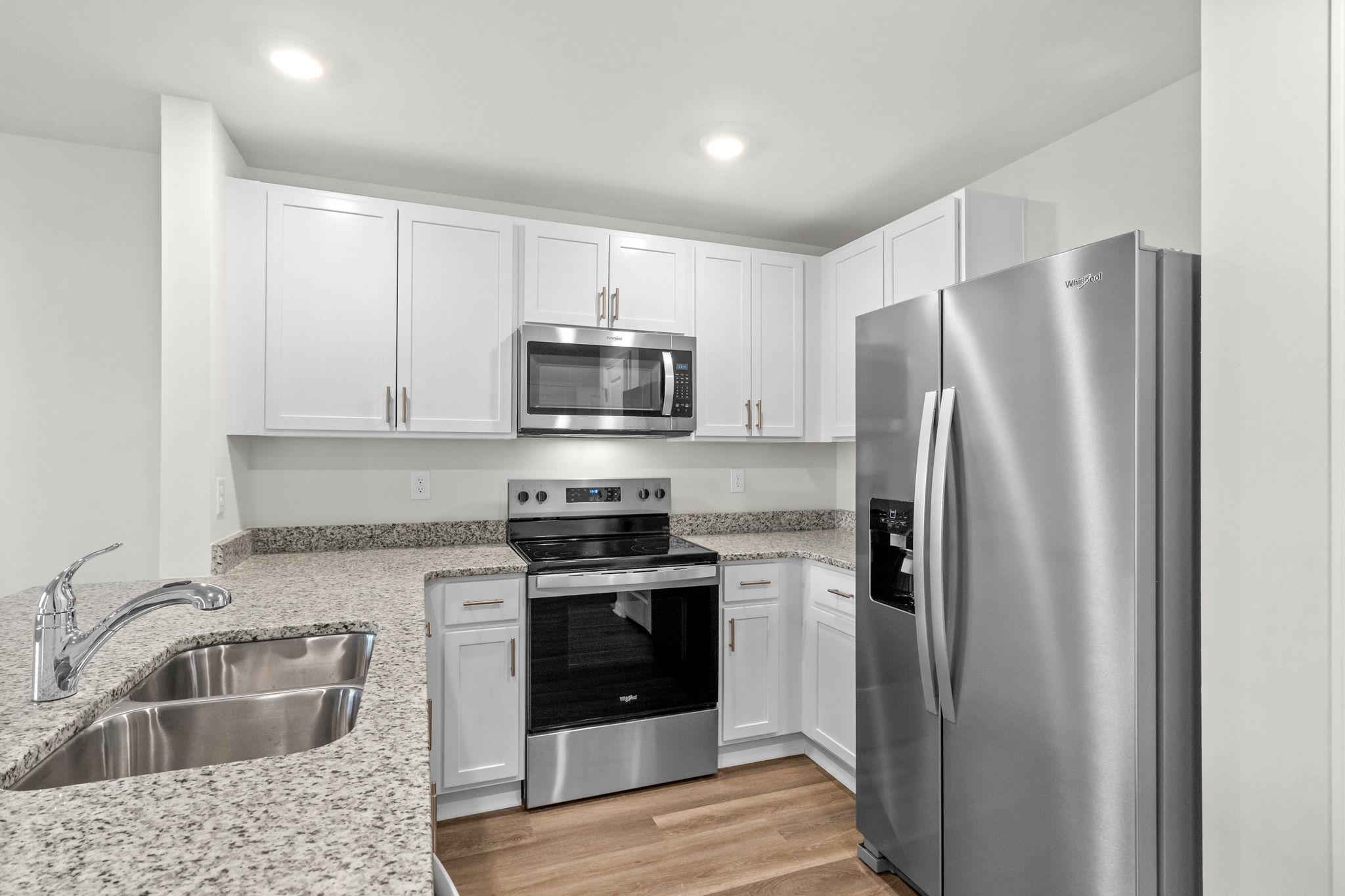 640 Golden Resin Road Conway, SC 29526 - Photo 11 of 38 Kitchen featuring appliances with stainless steel finishes, white cabinetry, light wood finished floors, light stone countertops, and recessed lighting