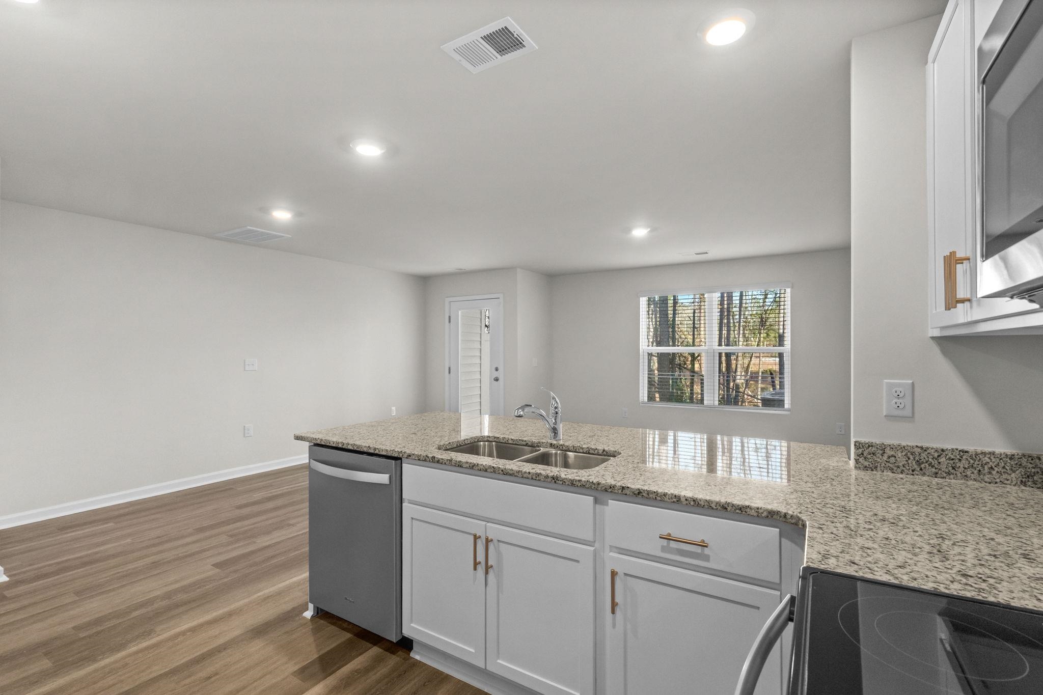 640 Golden Resin Road Conway, SC 29526 - Photo 12 of 38 Kitchen featuring a peninsula, white cabinetry, light stone countertops, appliances with stainless steel finishes, and recessed lighting