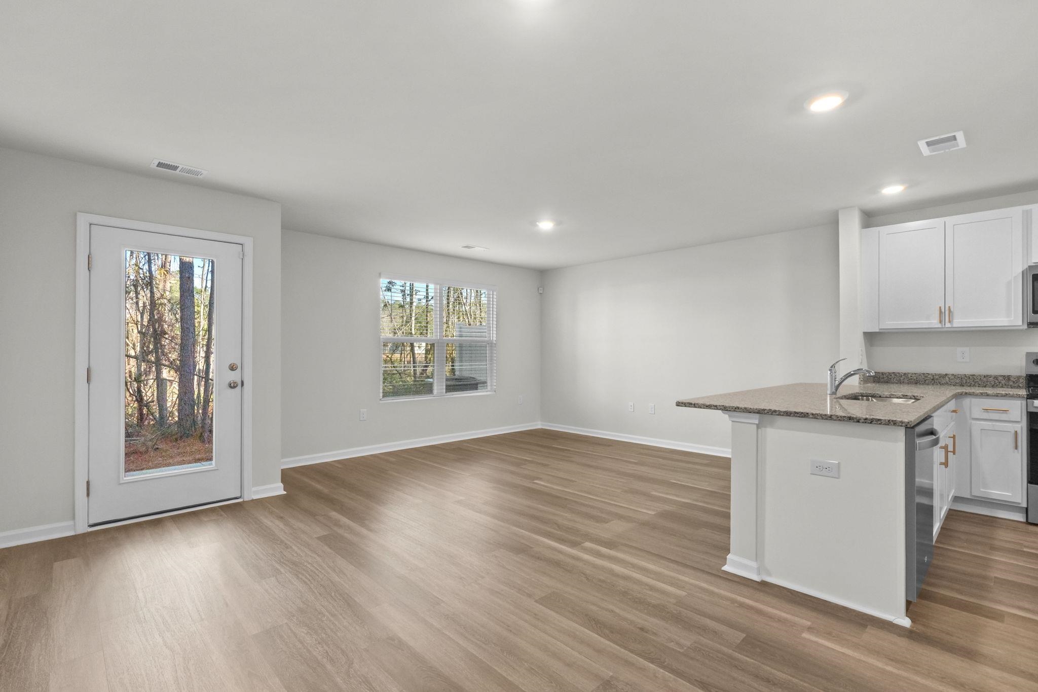 640 Golden Resin Road Conway, SC 29526 - Photo 38 of 38 Kitchen with white cabinets, dark stone countertops, light wood-style floors, recessed lighting, and open floor plan