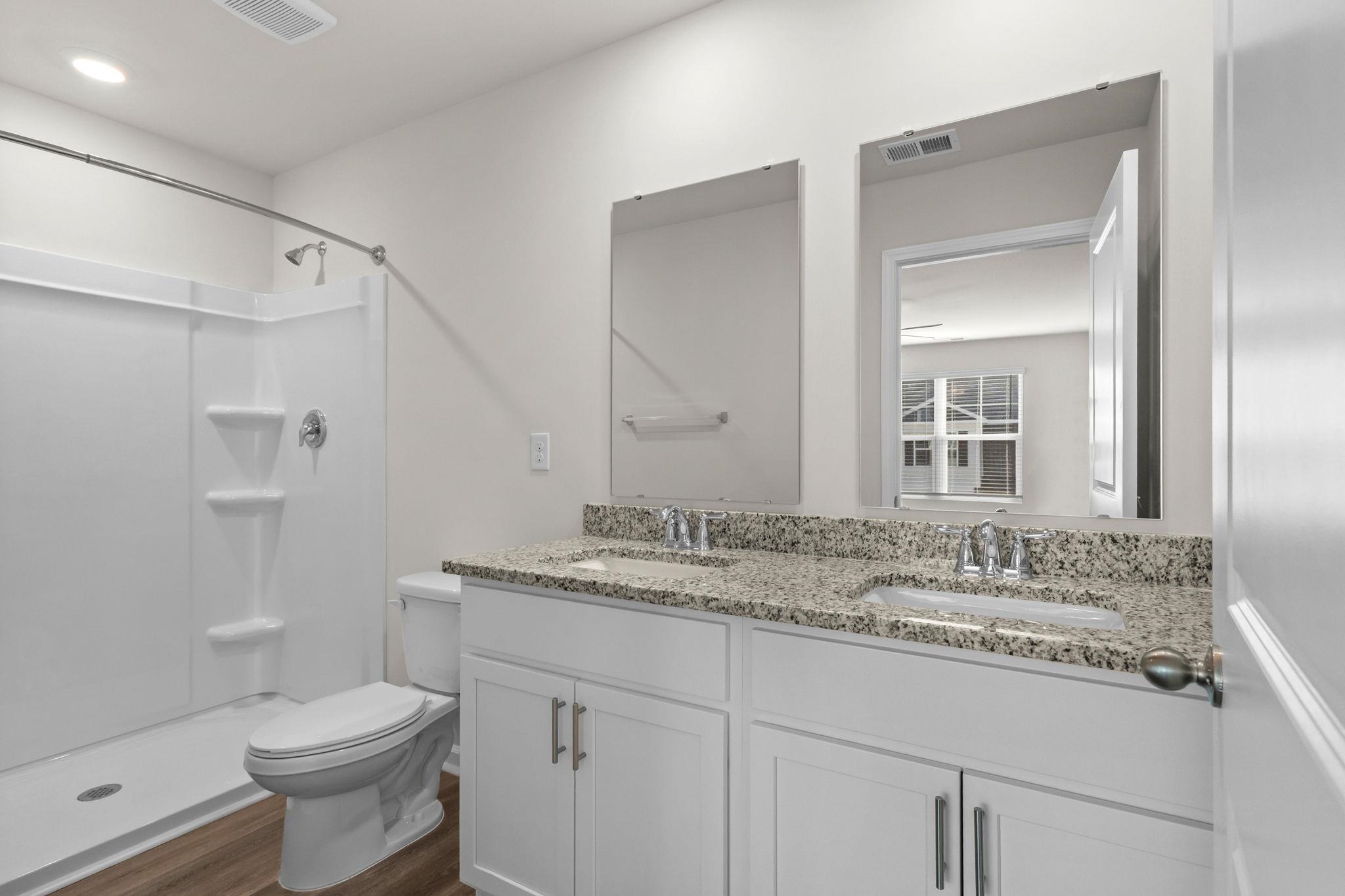 640 Golden Resin Road Conway, SC 29526 - Photo 20 of 38 Bathroom with double vanity, a shower, and dark wood-style flooring