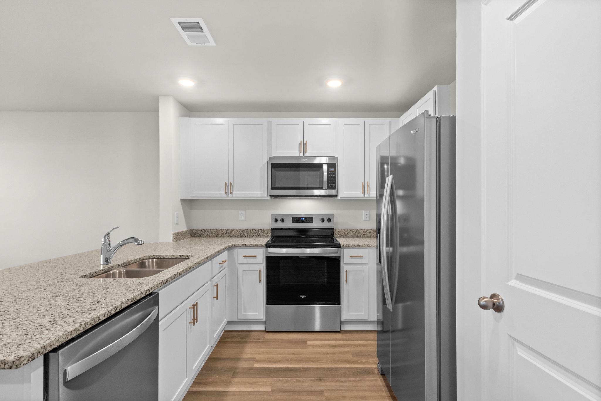 640 Golden Resin Road Conway, SC 29526 - Photo 10 of 38 Kitchen featuring stainless steel appliances, white cabinetry, a peninsula, light stone countertops, and recessed lighting