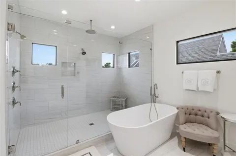 a white bath tub sitting next to a white toilet