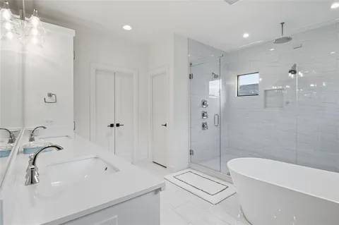 a bathroom with a tub sink a toilet and a shower