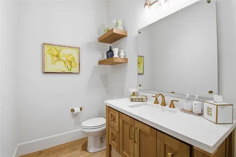 a bathroom with a toilet sink and mirror
