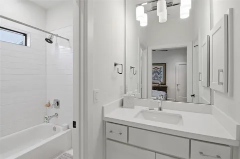 a bathroom with a sink a mirror and a bathtub