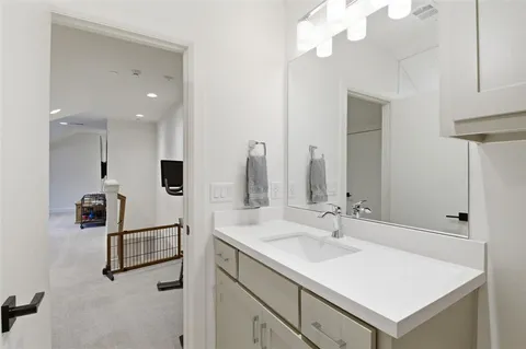 a bathroom with a sink a vanity and a mirror