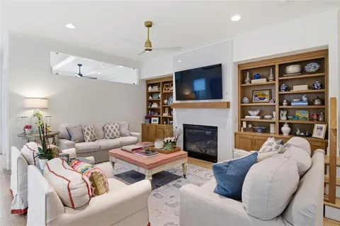 a living room with fireplace furniture and a flat screen tv