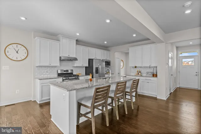 a kitchen with a table and chairs in it