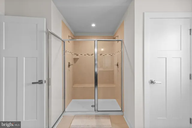 a view of an empty room with a ceiling fan