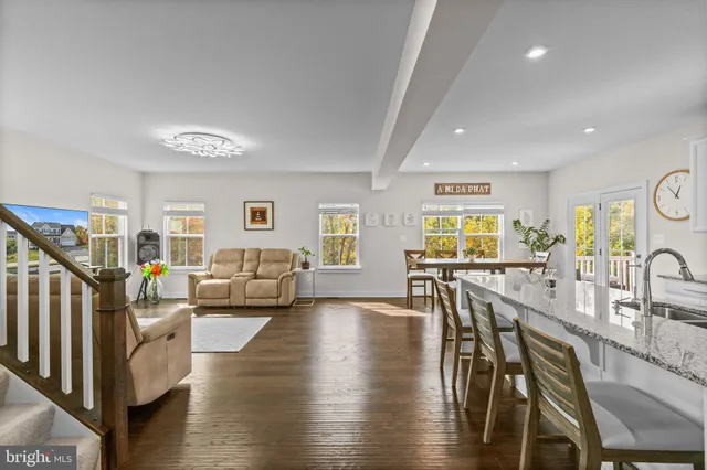 a living room with fireplace furniture and a wooden floor