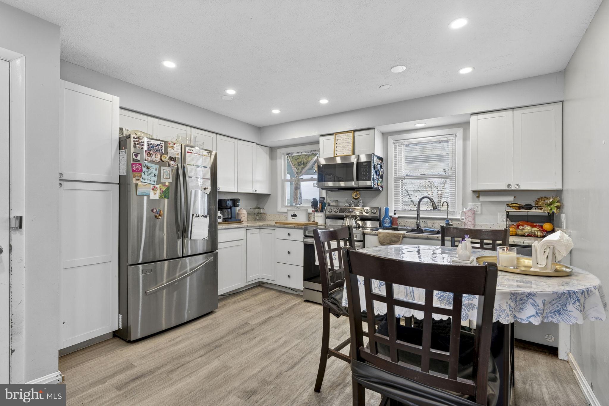 110 Bucks Mill Road Strasburg, VA 22657 - Photo 22 of 53 a kitchen with kitchen island white cabinets and stainless steel appliances