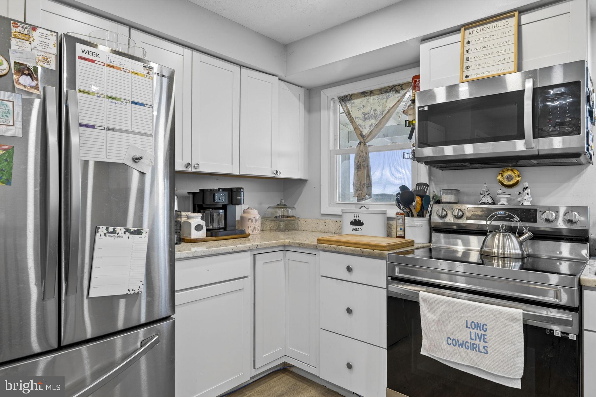 110 Bucks Mill Road Strasburg, VA 22657 - Photo 24 of 53 a kitchen with stainless steel appliances a stove microwave and sink