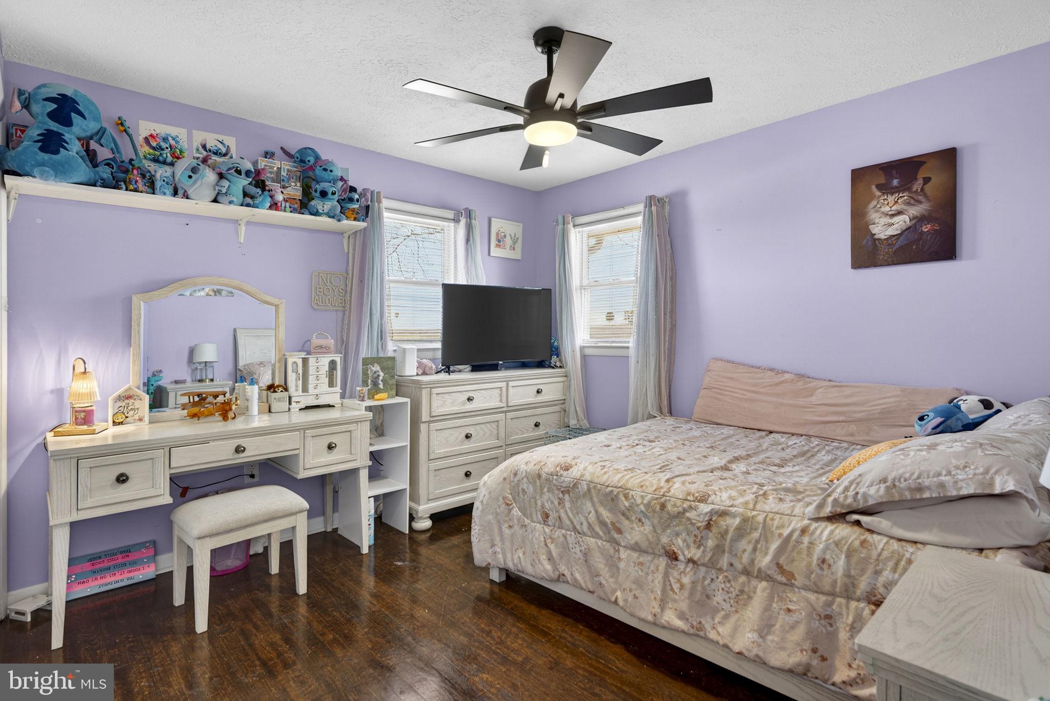 110 Bucks Mill Road Strasburg, VA 22657 - Photo 28 of 53 a bedroom with a bed a chandelier and a flat screen tv