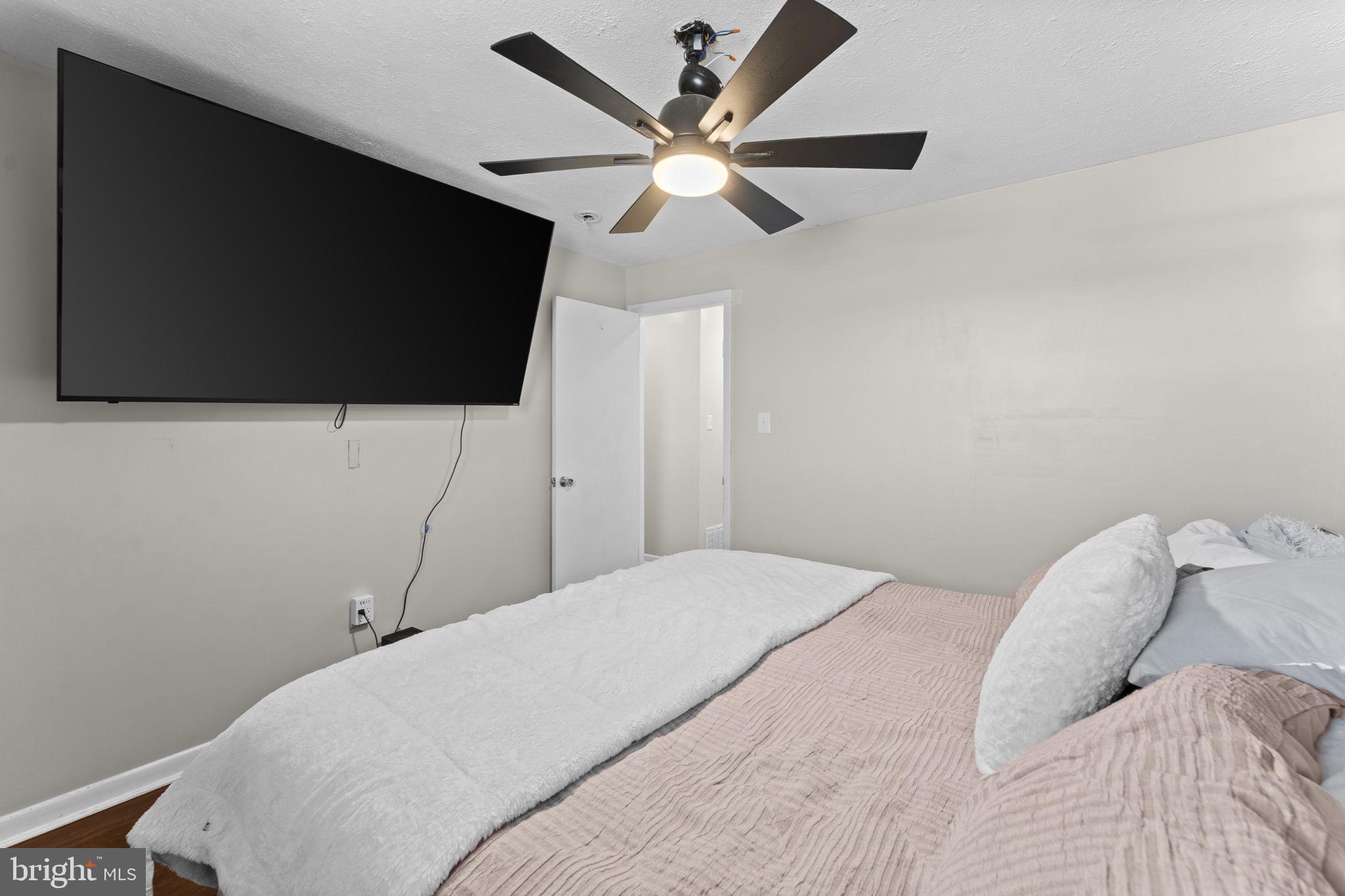 110 Bucks Mill Road Strasburg, VA 22657 - Photo 35 of 53 a bedroom with a bed and a flat screen tv