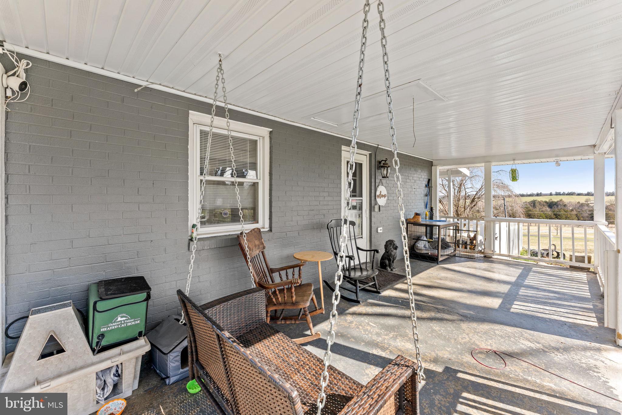 110 Bucks Mill Road Strasburg, VA 22657 - Photo 42 of 53 a dining room with furniture and a floor to ceiling window