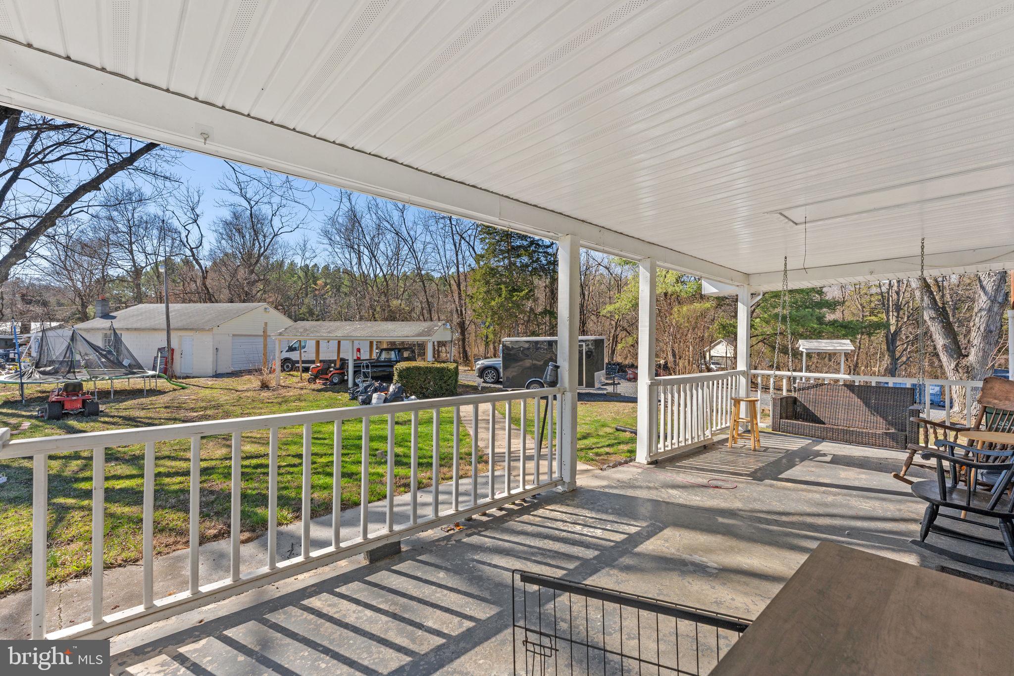 110 Bucks Mill Road Strasburg, VA 22657 - Photo 43 of 53 a view of a patio with a table chairs and a backyard