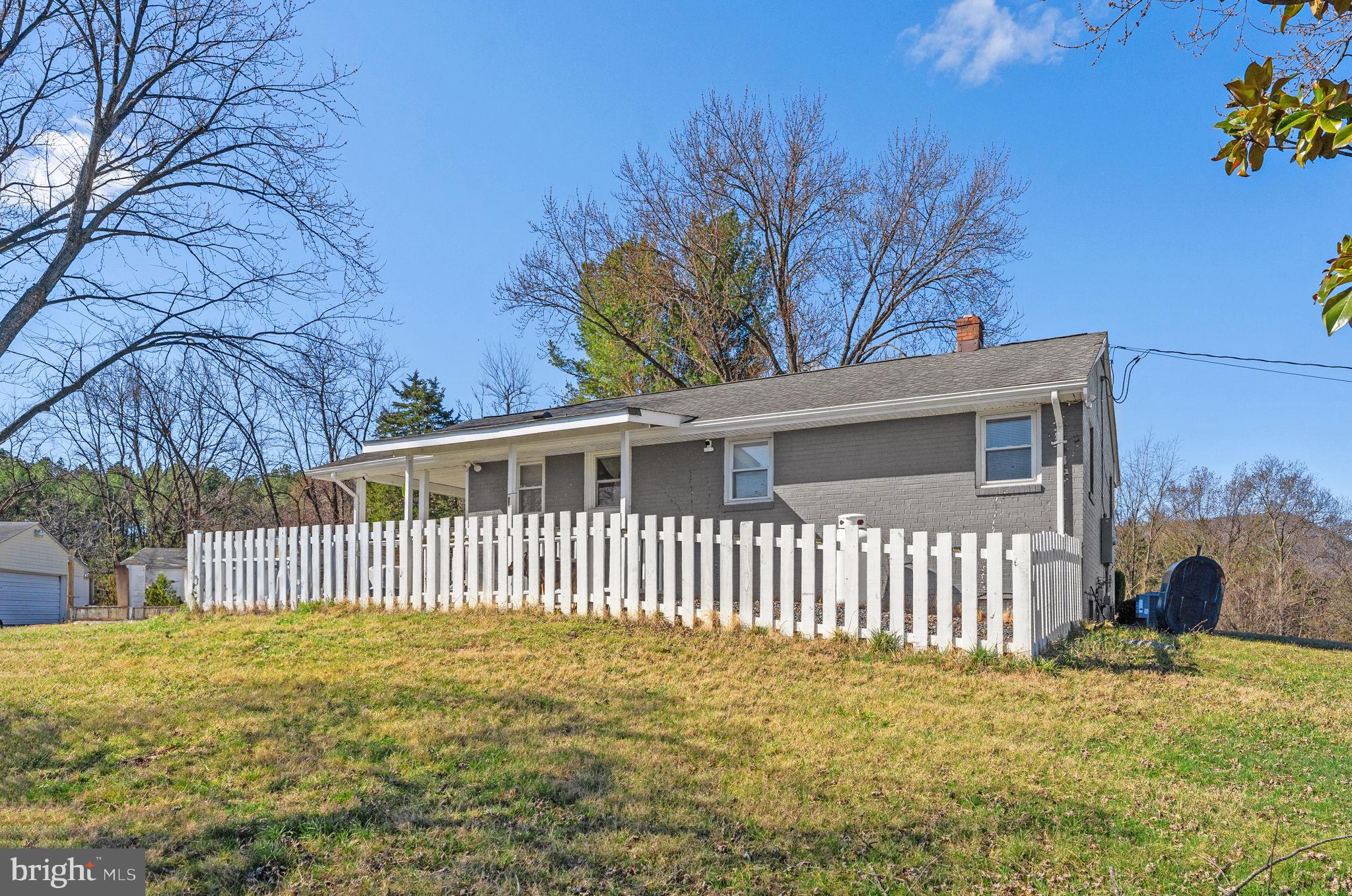 110 Bucks Mill Road Strasburg, VA 22657 - Photo 49 of 53 a view of a house with a small yard and a garden
