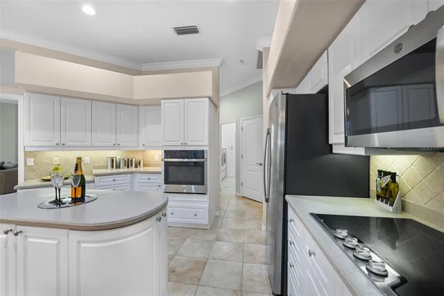 a kitchen with stainless steel appliances a refrigerator sink and cabinets