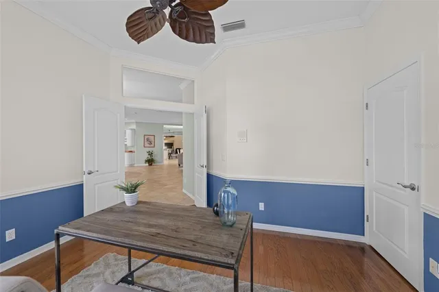 a view of an empty room with a window and a ceiling fan